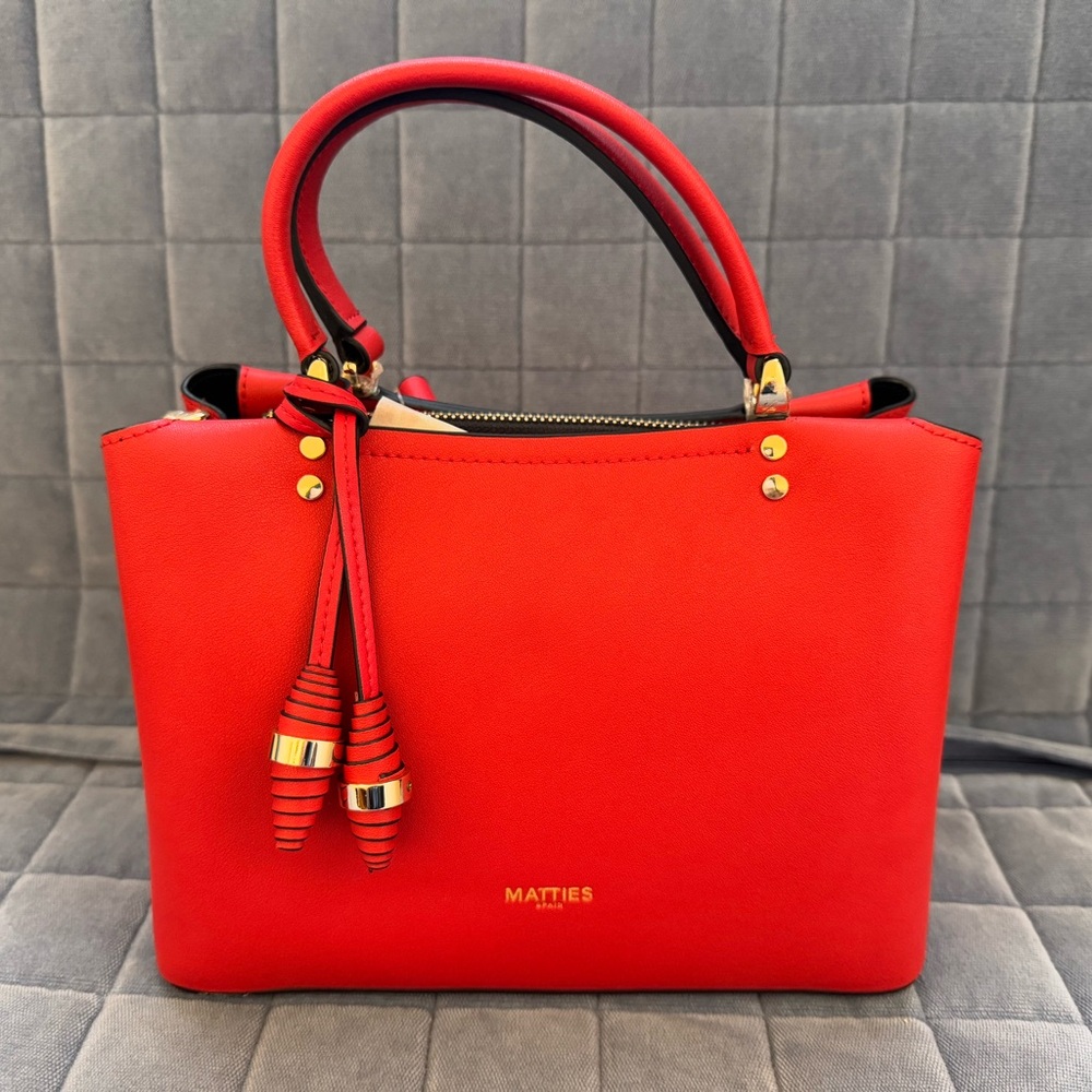 Vibrant Red Satchel with Structured Shape and Decorative Tassel